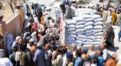long queues show   fight for food  continues in pakistan