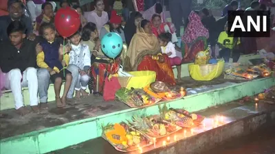 devotees gather to offer  argha  to rising sun as they observe chhath puja